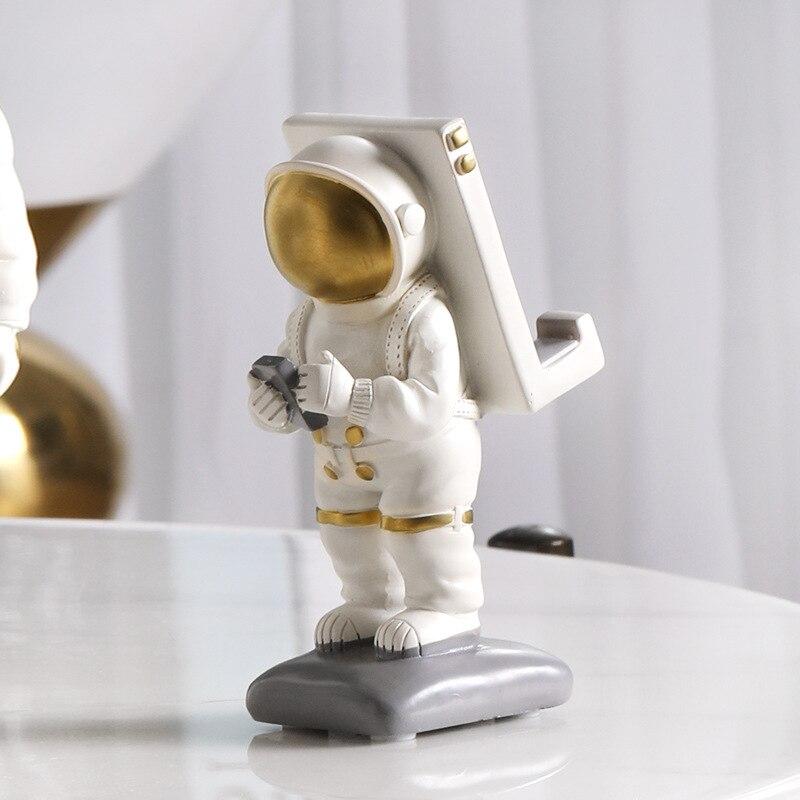 Astronaut standbeeld met telefoonhouder